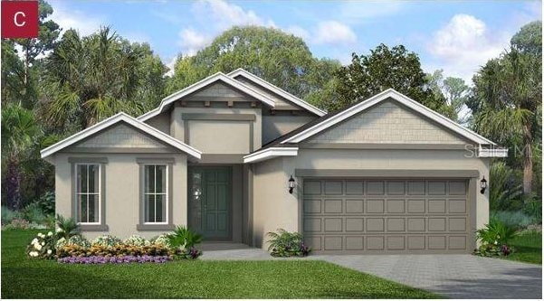 2357 Sirena Ln, Mount Dora, FL 32757 - view of front of property with an attached garage, stucco siding, and driveway