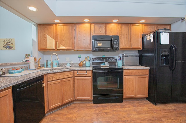 4545 Southfield Ave, Orlando, FL 32812 - kitchen with black appliances, light countertops, wood finished floors, and recessed lighting