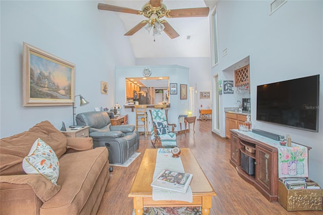 4545 Southfield Ave, Orlando, FL 32812 - living area with high vaulted ceiling, ceiling fan, and wood finished floors