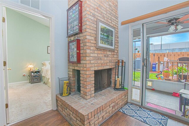 4545 Southfield Ave, Orlando, FL 32812 - living room featuring wood finished floors, ceiling fan, and a brick fireplace