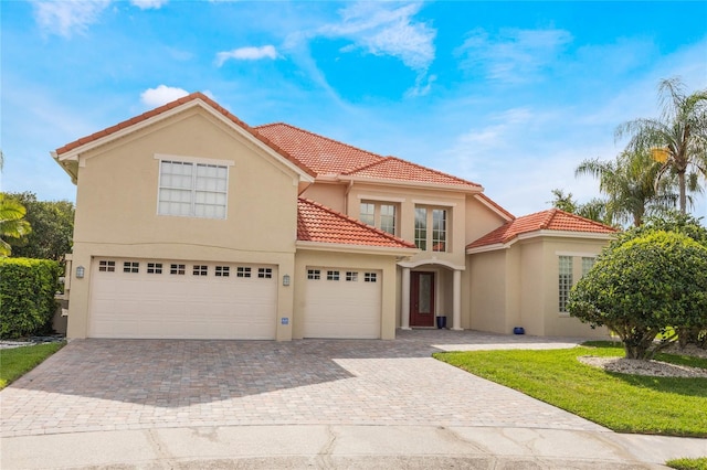 9062 Dancy Tree Ct, Orlando, FL 32836 - mediterranean / spanish house with stucco siding, decorative driveway, a tile roof, and a garage