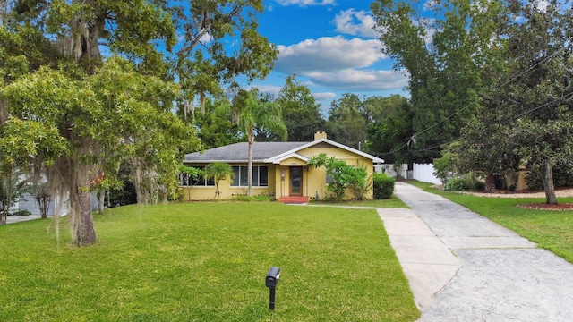 328 E Minnehaha Ave, Clermont, FL 34711 - ranch-style home featuring concrete driveway, a front yard, and a chimney