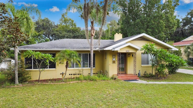 328 E Minnehaha Ave, Clermont, FL 34711 - single story home with stucco siding, a front yard, a chimney, and roof with shingles