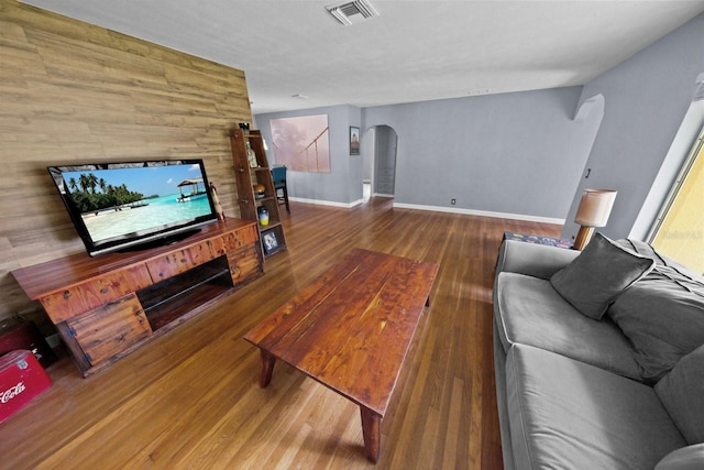 328 E Minnehaha Ave, Clermont, FL 34711 - living area with arched walkways, wood finished floors, baseboards, and wood walls