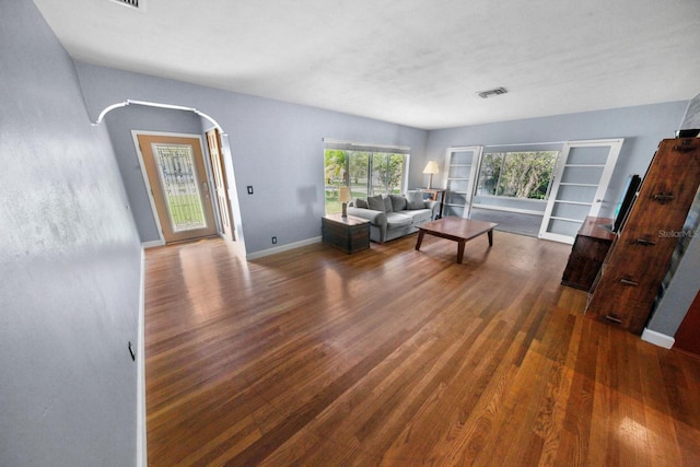 328 E Minnehaha Ave, Clermont, FL 34711 - living area with arched walkways, wood finished floors, and baseboards
