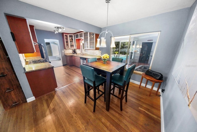 328 E Minnehaha Ave, Clermont, FL 34711 - dining space with wood finished floors, a chandelier, and baseboards