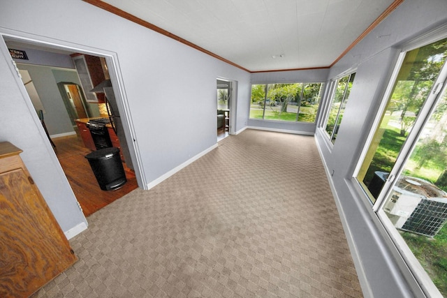 328 E Minnehaha Ave, Clermont, FL 34711 - corridor with healthy amount of natural light, carpet floors, ornamental molding, baseboards, and arched walkways
