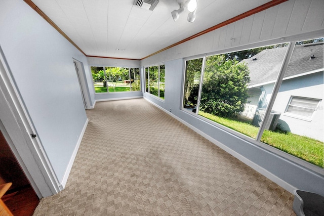 328 E Minnehaha Ave, Clermont, FL 34711 - unfurnished sunroom with baseboards, crown molding, and carpet floors