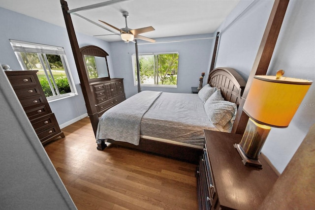 328 E Minnehaha Ave, Clermont, FL 34711 - bedroom with multiple windows, wood finished floors, a ceiling fan, and baseboards