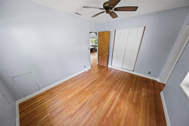 328 E Minnehaha Ave, Clermont, FL 34711 - unfurnished bedroom featuring wood finished floors, a closet, baseboards, and a ceiling fan