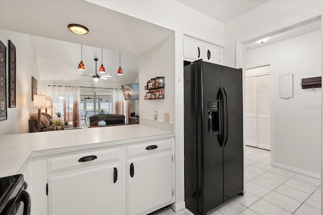1126 Villa Ln Unit 91, Apopka, FL 32712 - kitchen with black fridge, light countertops, ceiling fan, and light tile patterned floors