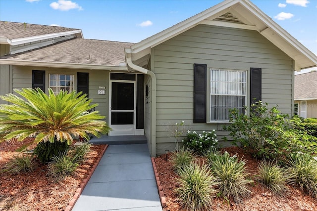 1126 Villa Ln Unit 91, Apopka, FL 32712 - view of exterior entry with a shingled roof
