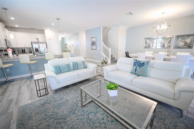 9014 Stinger Dr, Davenport, FL 33896 - living room with stairway, recessed lighting, and a chandelier