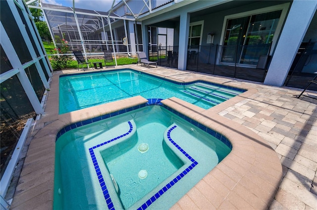 9014 Stinger Dr, Davenport, FL 33896 - view of pool featuring a patio, a pool with connected hot tub, and glass enclosure