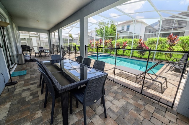 9014 Stinger Dr, Davenport, FL 33896 - sunroom / solarium with a hot tub, outdoor dining space, and a pool