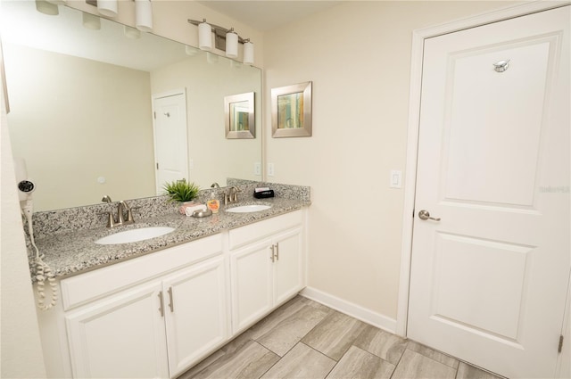 9014 Stinger Dr, Davenport, FL 33896 - full bathroom featuring double vanity and baseboards