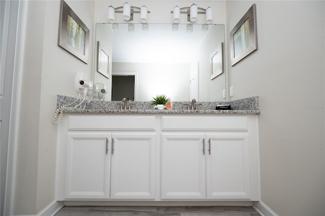 9014 Stinger Dr, Davenport, FL 33896 - bathroom with double vanity and baseboards
