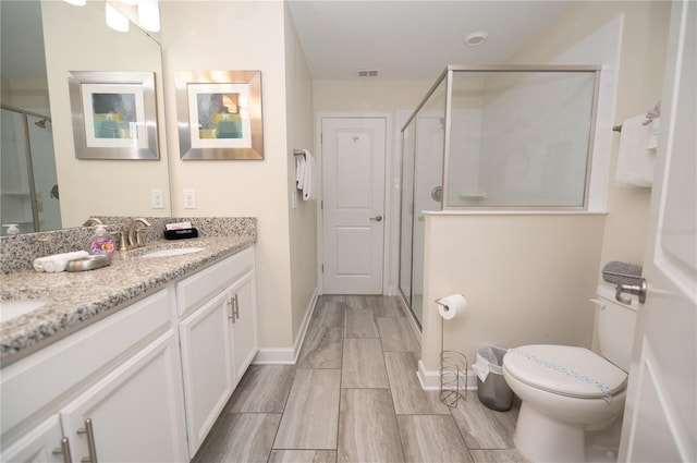 9014 Stinger Dr, Davenport, FL 33896 - full bathroom with double vanity, a shower stall, and wood finish floors