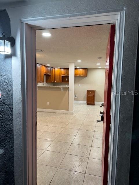2847 W Harwood St Unit 0, Orlando, FL 32805 - hall featuring light tile patterned floors, recessed lighting, and a textured wall