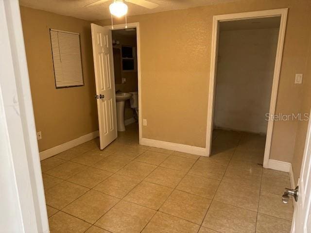 2847 W Harwood St Unit 0, Orlando, FL 32805 - unfurnished bedroom featuring light tile patterned floors and a ceiling fan