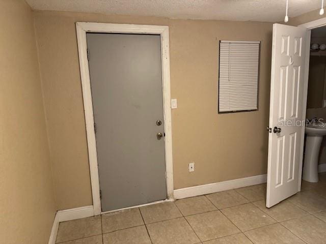 2847 W Harwood St Unit 0, Orlando, FL 32805 - entryway with light tile patterned floors and a textured ceiling