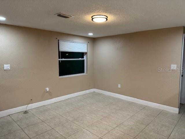 2847 W Harwood St Unit 0, Orlando, FL 32805 - empty room with a textured ceiling, recessed lighting, and light tile patterned floors