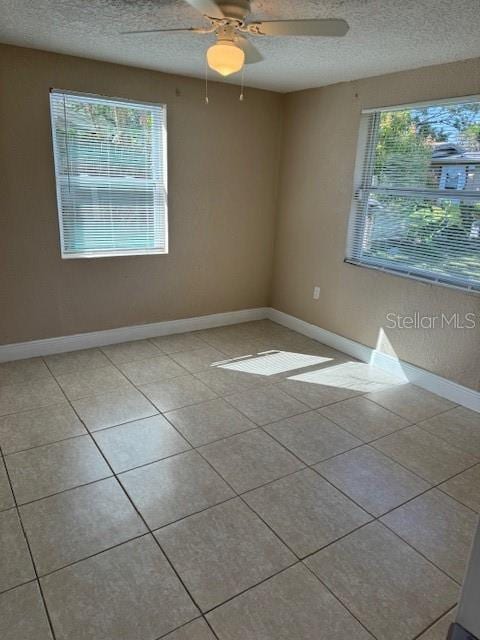 2847 W Harwood St Unit 0, Orlando, FL 32805 - tiled spare room featuring a textured ceiling and a ceiling fan