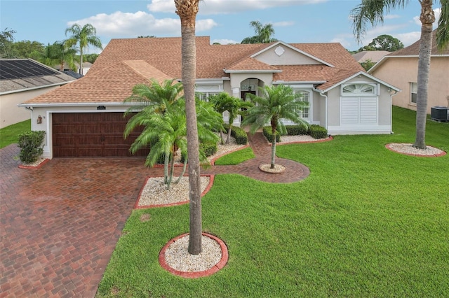 970 Sabal Grove Dr, Rockledge, FL 32955 - mediterranean / spanish home featuring stucco siding, a garage, a shingled roof, driveway, and a front yard