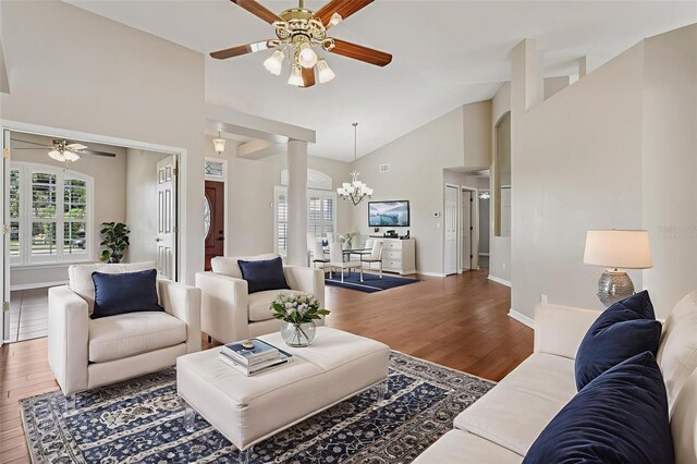 970 Sabal Grove Dr, Rockledge, FL 32955 - living area with ceiling fan, wood finished floors, a chandelier, high vaulted ceiling, and baseboards