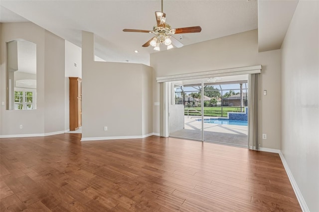 970 Sabal Grove Dr, Rockledge, FL 32955 - empty room featuring a ceiling fan, healthy amount of natural light, wood finished floors, and baseboards