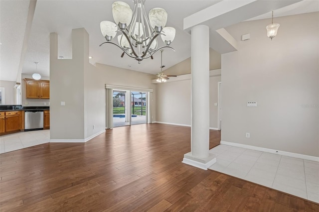 970 Sabal Grove Dr, Rockledge, FL 32955 - unfurnished living room featuring light wood finished floors, ornate columns, baseboards, high vaulted ceiling, and a chandelier