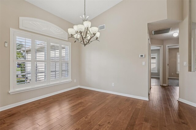 970 Sabal Grove Dr, Rockledge, FL 32955 - unfurnished dining area featuring a chandelier, dark wood-type flooring, baseboards, and vaulted ceiling