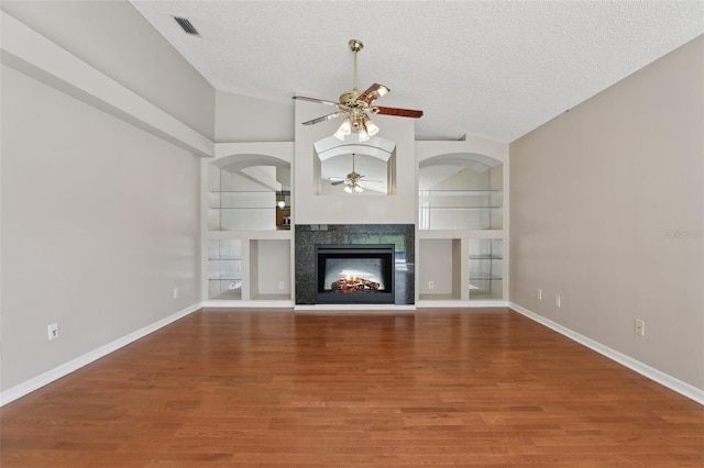 970 Sabal Grove Dr, Rockledge, FL 32955 - unfurnished living room with a ceiling fan, a textured ceiling, wood finished floors, a multi sided fireplace, and lofted ceiling