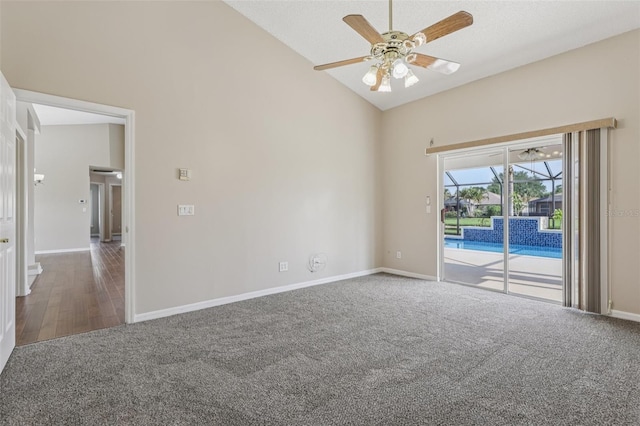 970 Sabal Grove Dr, Rockledge, FL 32955 - carpeted empty room featuring ceiling fan, high vaulted ceiling, baseboards, and wood finished floors