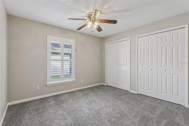 970 Sabal Grove Dr, Rockledge, FL 32955 - unfurnished bedroom with multiple closets, carpet floors, a textured ceiling, baseboards, and ceiling fan