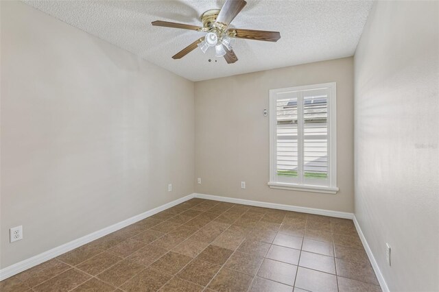 970 Sabal Grove Dr, Rockledge, FL 32955 - empty room featuring a textured ceiling, ceiling fan, baseboards, and dark tile patterned floors