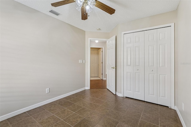 970 Sabal Grove Dr, Rockledge, FL 32955 - unfurnished bedroom with a textured ceiling, baseboards, a closet, and ceiling fan