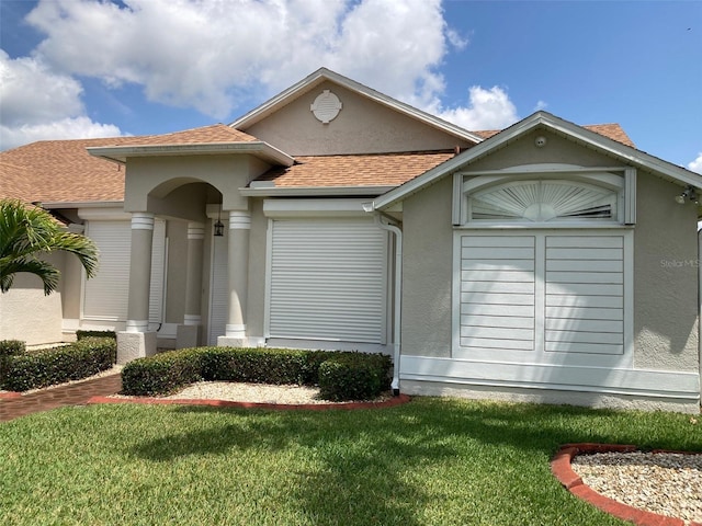 970 Sabal Grove Dr, Rockledge, FL 32955 - view of front of property with a front lawn, a shingled roof, and stucco siding