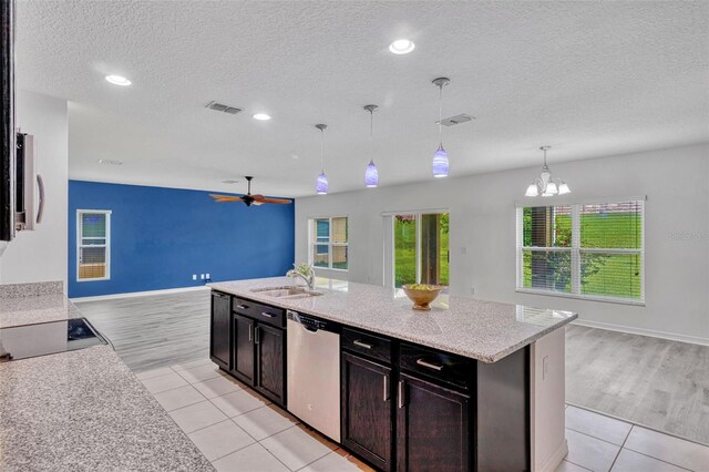 144 Williamson Dr, Davenport, FL 33897 - kitchen with open floor plan, dishwasher, a sink, black electric cooktop, and a textured ceiling
