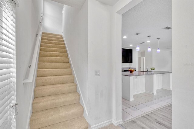 144 Williamson Dr, Davenport, FL 33897 - staircase with recessed lighting, baseboards, and wood finished floors