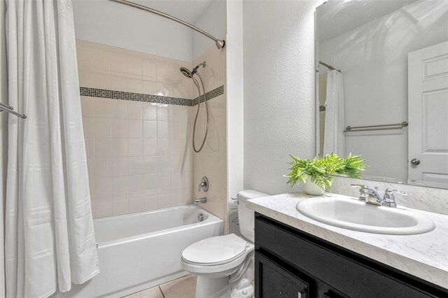 144 Williamson Dr, Davenport, FL 33897 - bathroom featuring shower / bath combination with curtain, toilet, vanity, tile patterned floors, and a textured wall