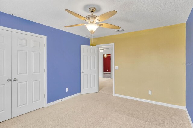 144 Williamson Dr, Davenport, FL 33897 - unfurnished bedroom with carpet flooring, baseboards, a closet, a ceiling fan, and a textured ceiling