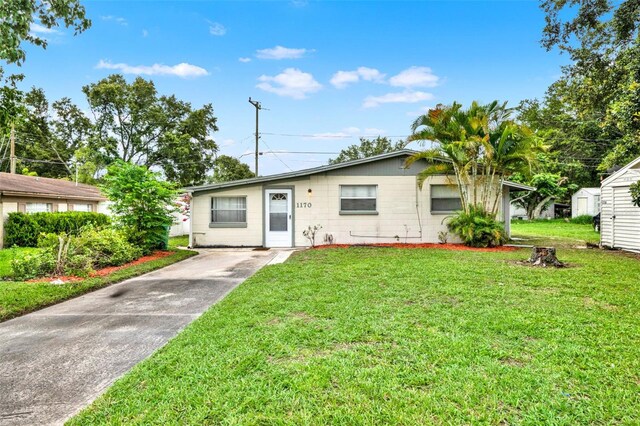 1170 E Bay St, Winter Garden, FL 34787 - ranch-style house featuring a front lawn, concrete driveway, and concrete block siding