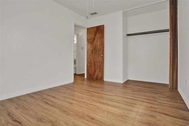 1170 E Bay St, Winter Garden, FL 34787 - unfurnished bedroom with a closet, light wood finished floors, and baseboards