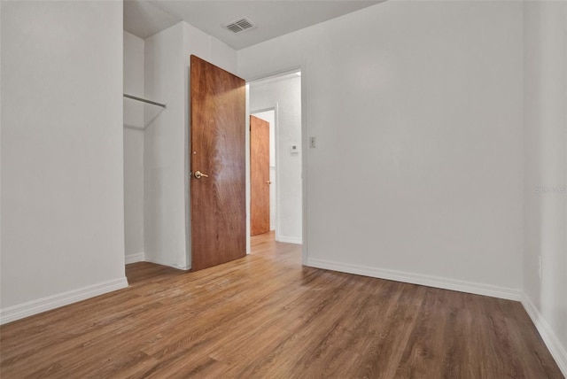 1170 E Bay St, Winter Garden, FL 34787 - unfurnished bedroom with wood finished floors and baseboards