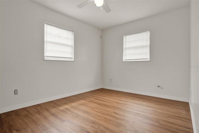 1170 E Bay St, Winter Garden, FL 34787 - spare room featuring plenty of natural light, light wood-style flooring, and baseboards
