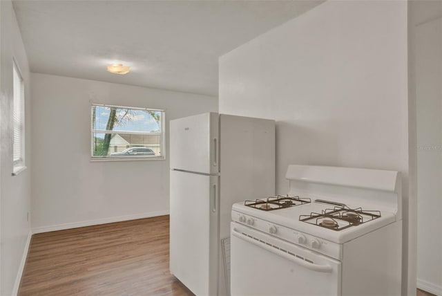 1170 E Bay St, Winter Garden, FL 34787 - kitchen with white range with gas stovetop, wood finished floors, and baseboards