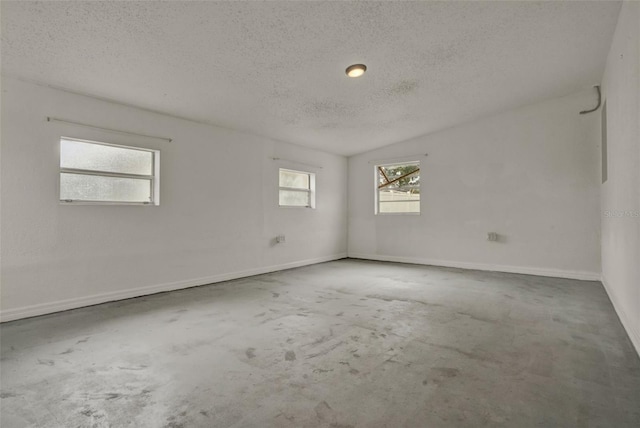 1170 E Bay St, Winter Garden, FL 34787 - spare room with a textured ceiling, concrete floors, and baseboards