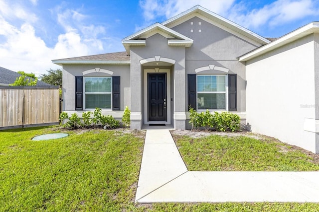 652 SW Mccoy Ave, Port St Lucie, FL 34953 - view of exterior entry featuring stucco siding