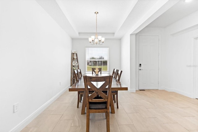 652 SW Mccoy Ave, Port St Lucie, FL 34953 - dining room with a chandelier, a tray ceiling, light tile patterned floors, and baseboards